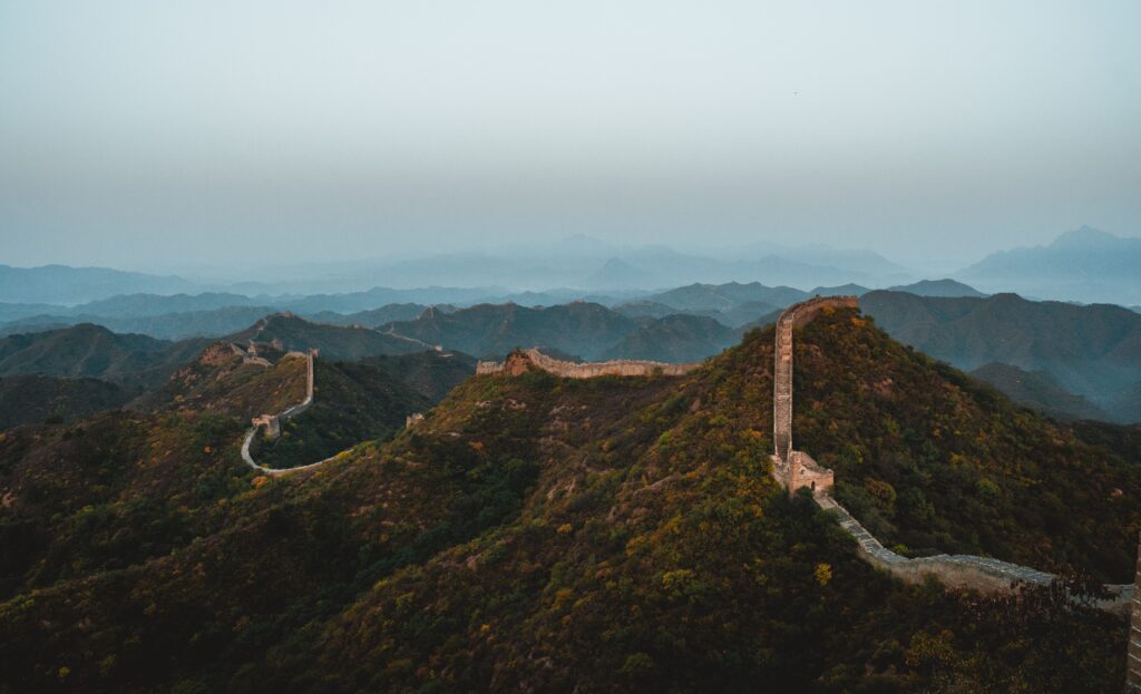 The Great Wall of China stretching across hills at dusk
