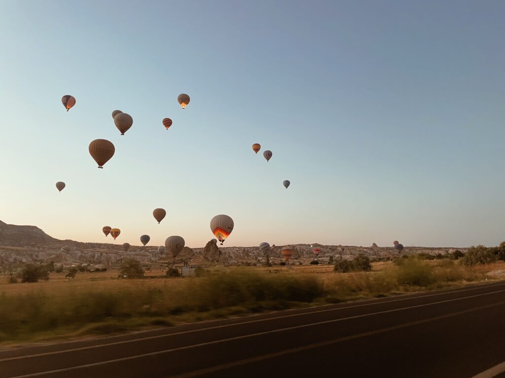 Hot air balloons floating over Cappadocia at sunrise